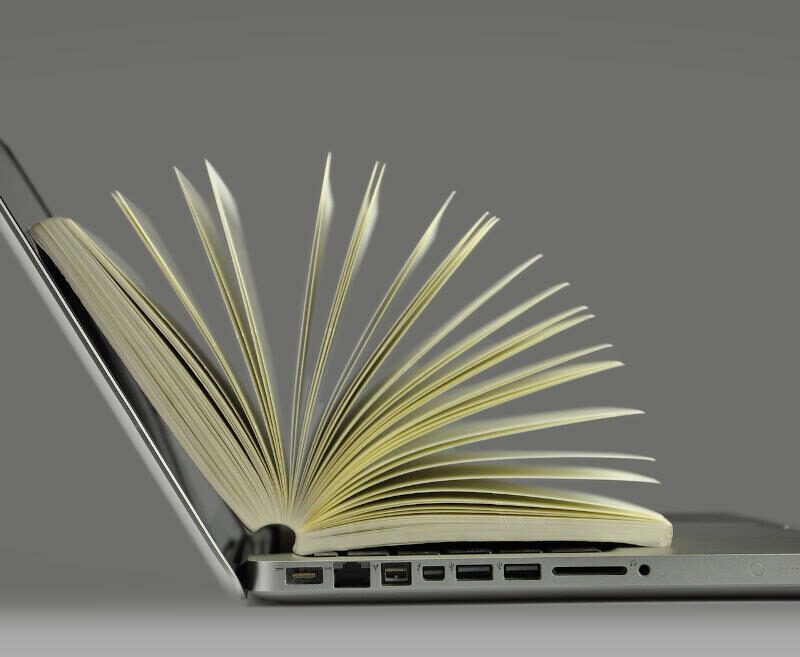 Laptop holding book